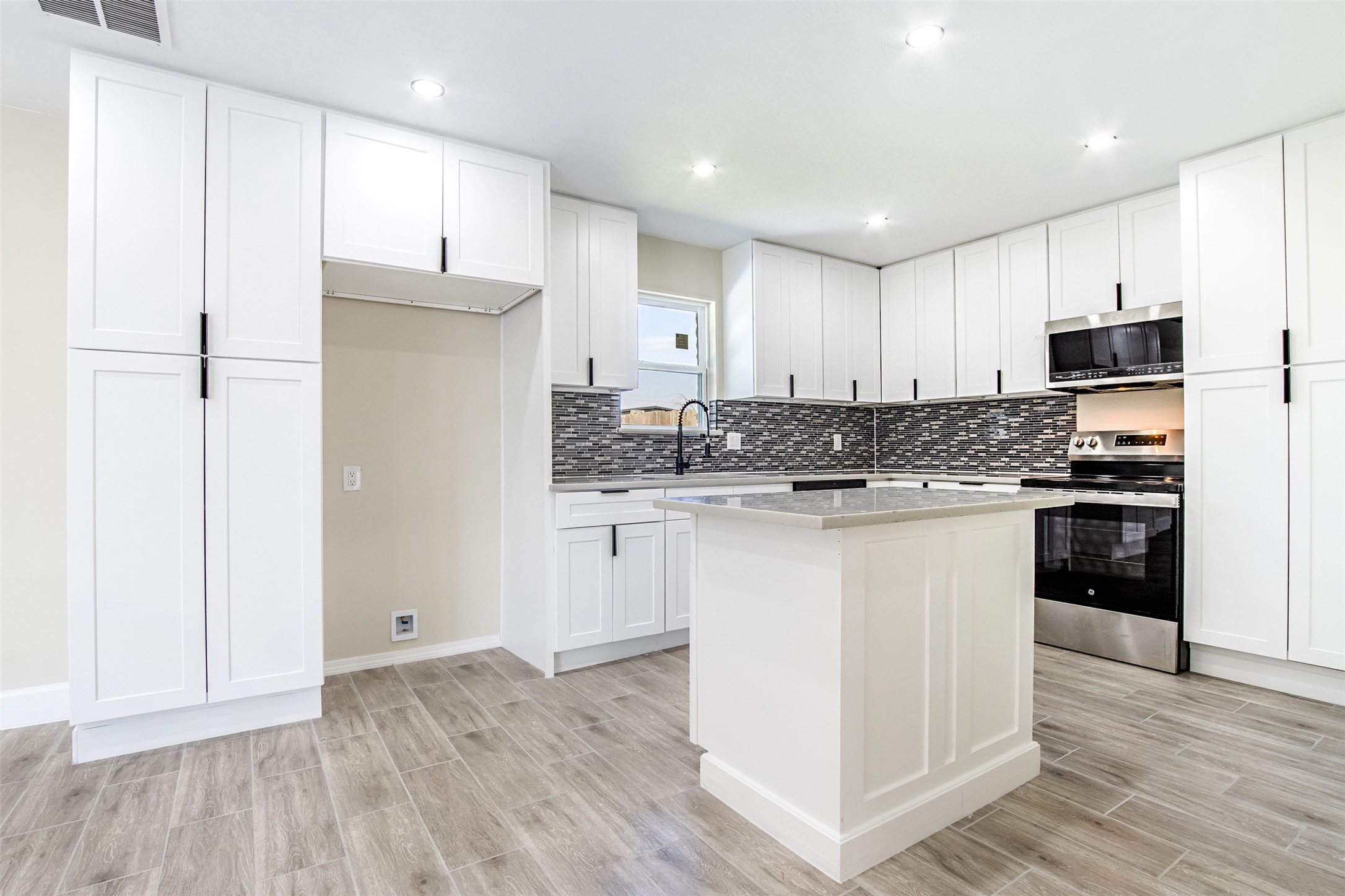 11203 Rousseau Drive Houston, TX 77065 - Photo 13 of 50 a kitchen with stainless steel appliances granite countertop a refrigerator sink and white cabinets