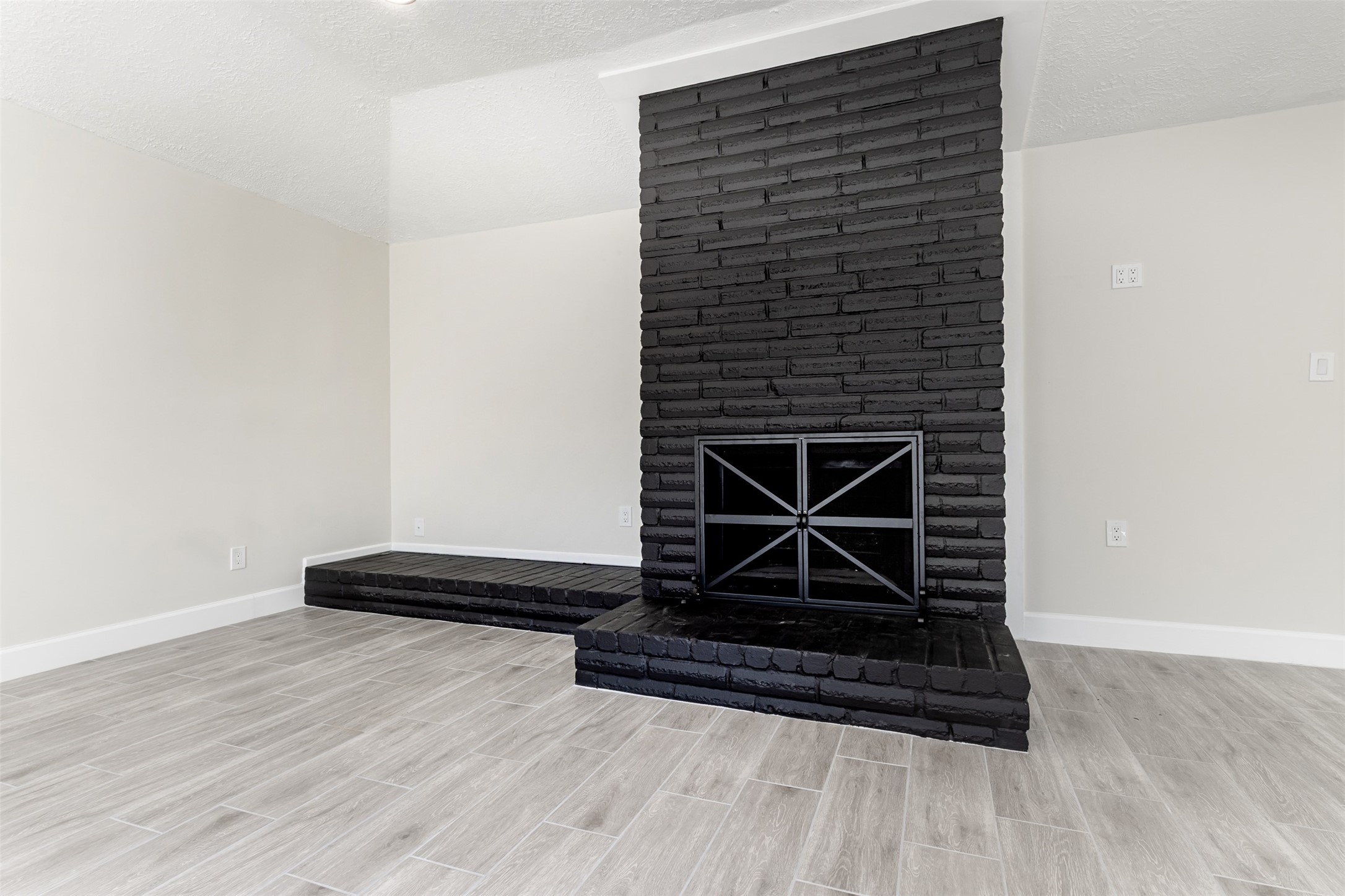 11203 Rousseau Drive Houston, TX 77065 - Photo 15 of 50 a view of fireplace with wooden floor