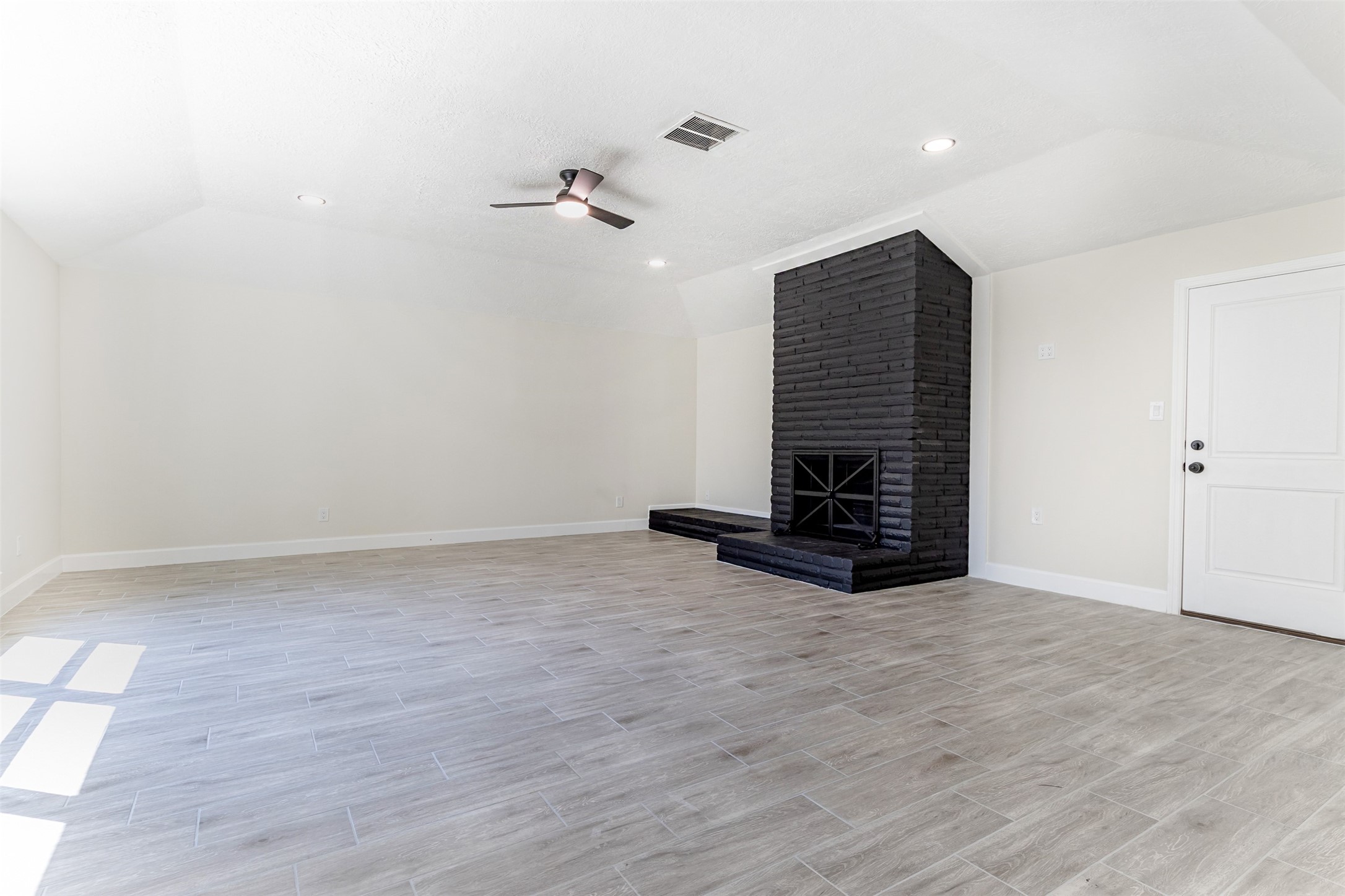 11203 Rousseau Drive Houston, TX 77065 - Photo 16 of 50 wooden floor in an empty room with a fireplace