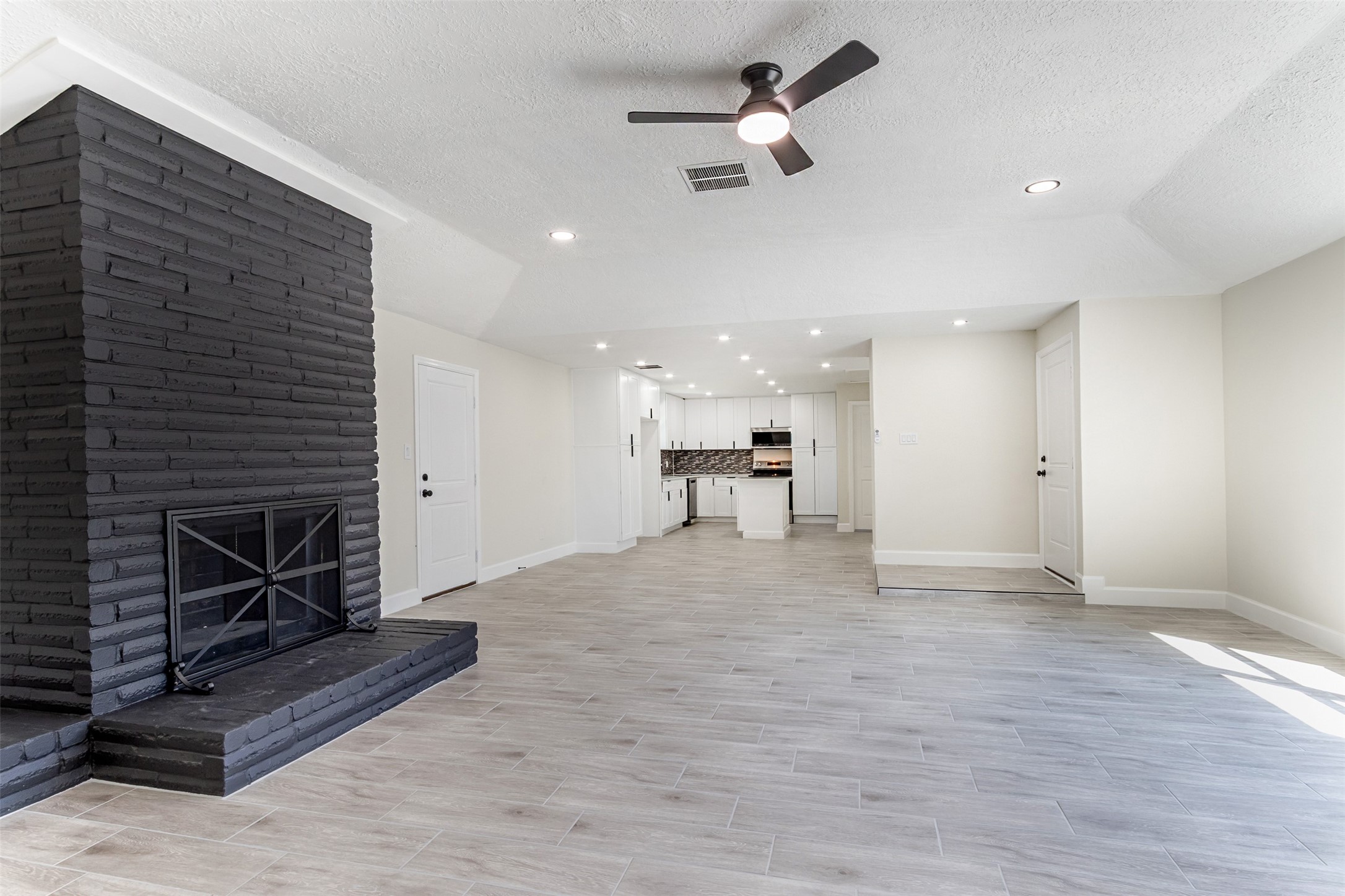 11203 Rousseau Drive Houston, TX 77065 - Photo 17 of 50 a view of empty room with a kitchen