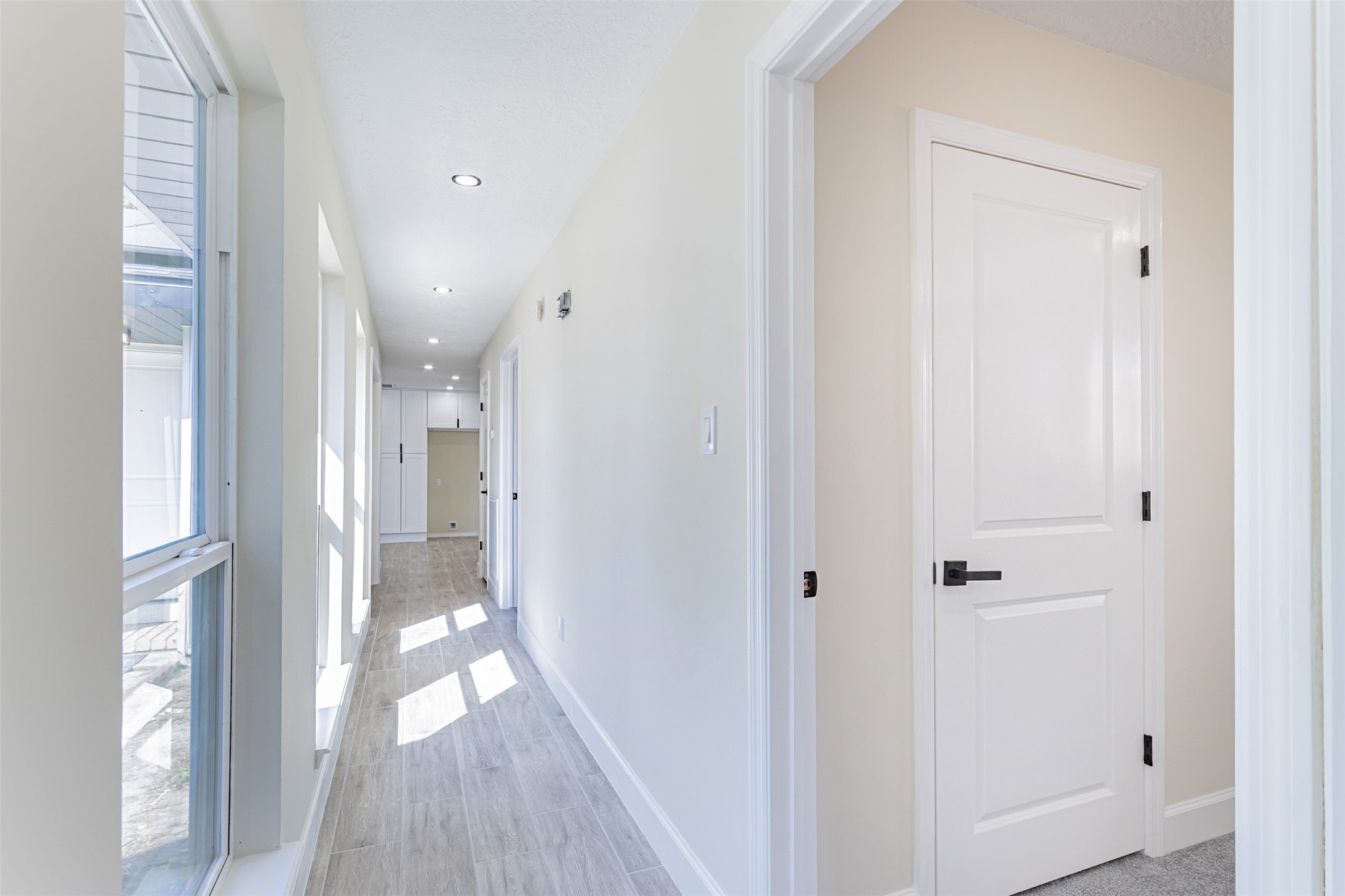 11203 Rousseau Drive Houston, TX 77065 - Photo 19 of 50 a view of hallway with livingroom and wooden floor