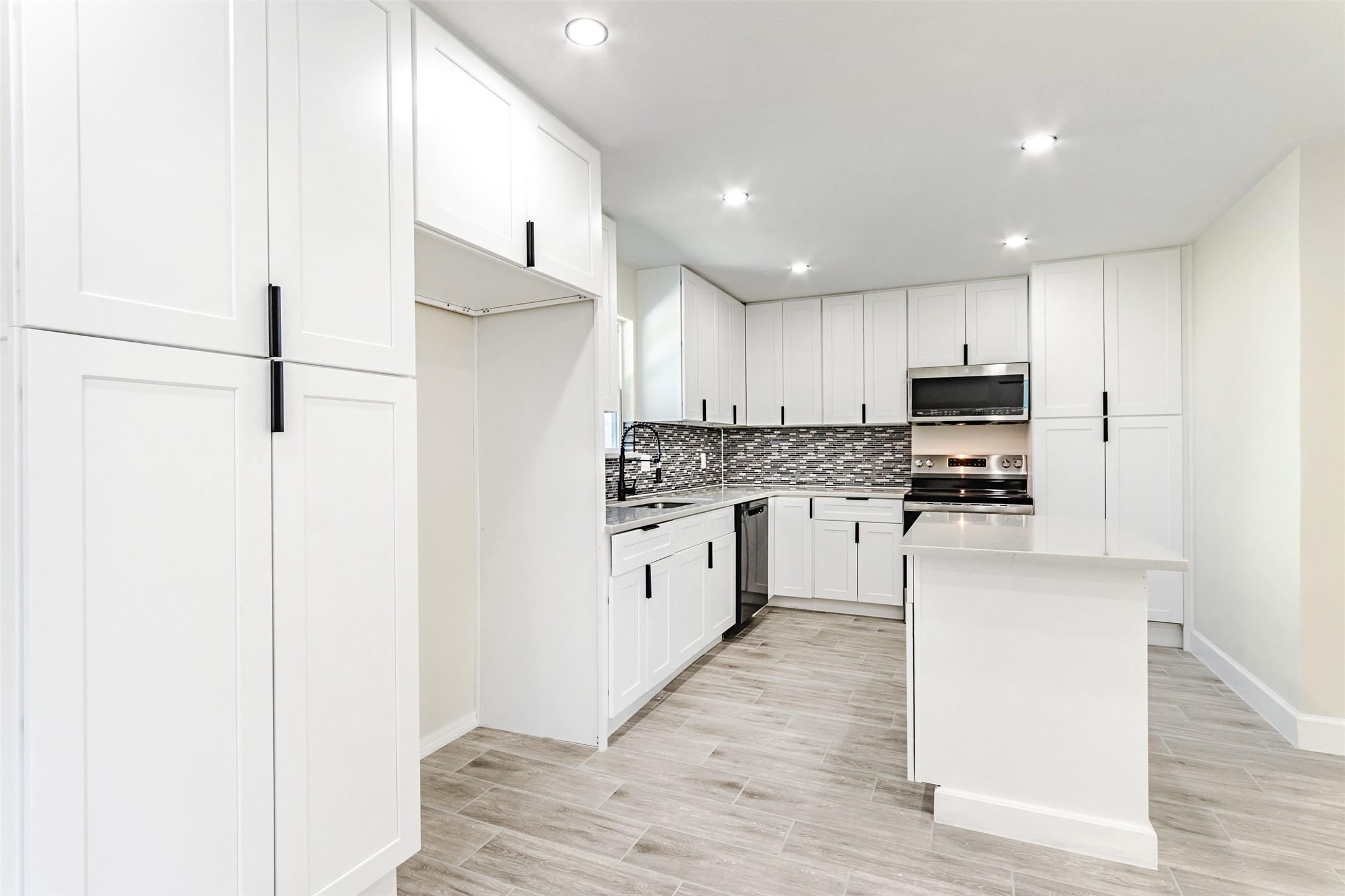 11203 Rousseau Drive Houston, TX 77065 - Photo 2 of 50 a kitchen with white cabinets and white appliances