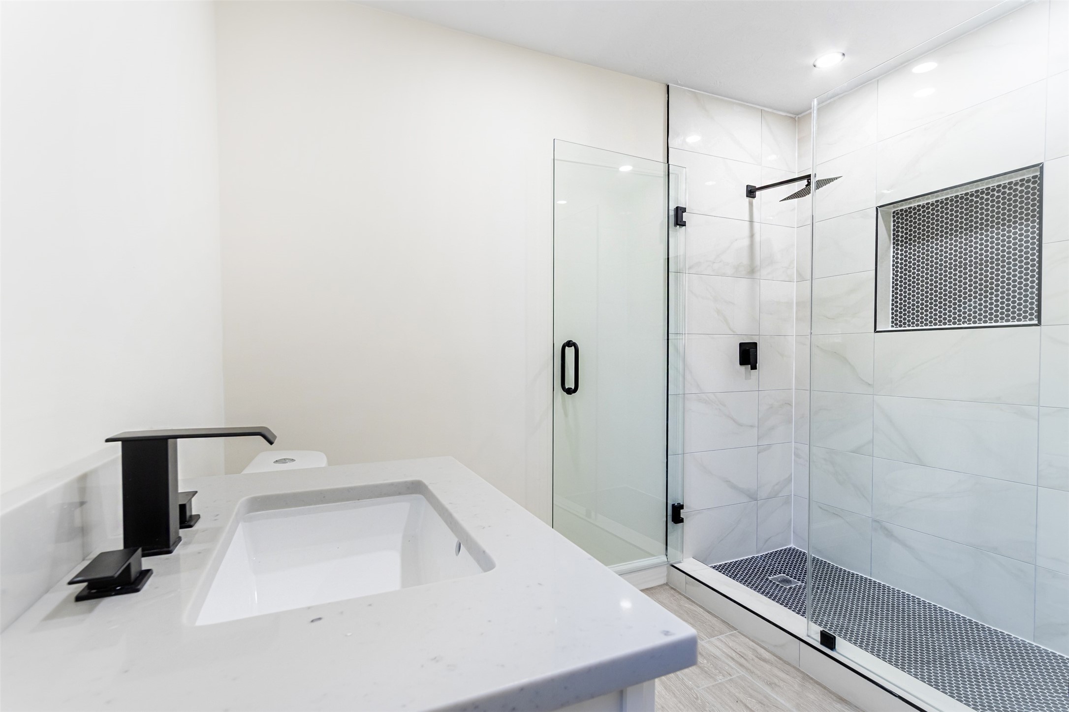 11203 Rousseau Drive Houston, TX 77065 - Photo 33 of 50 a bathroom with a sink a toilet and shower