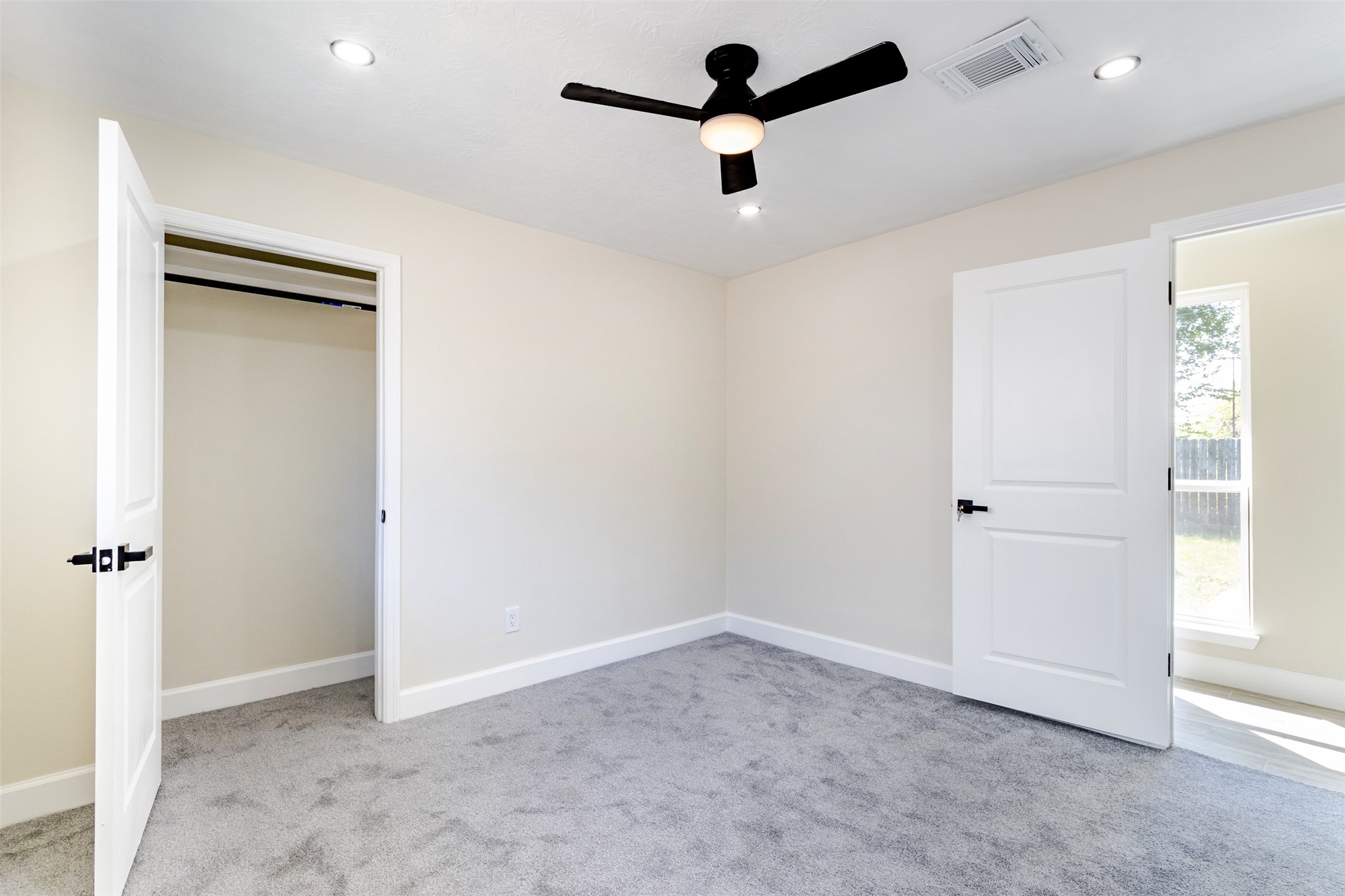 11203 Rousseau Drive Houston, TX 77065 - Photo 37 of 50 an empty room with a ceiling fan and a window