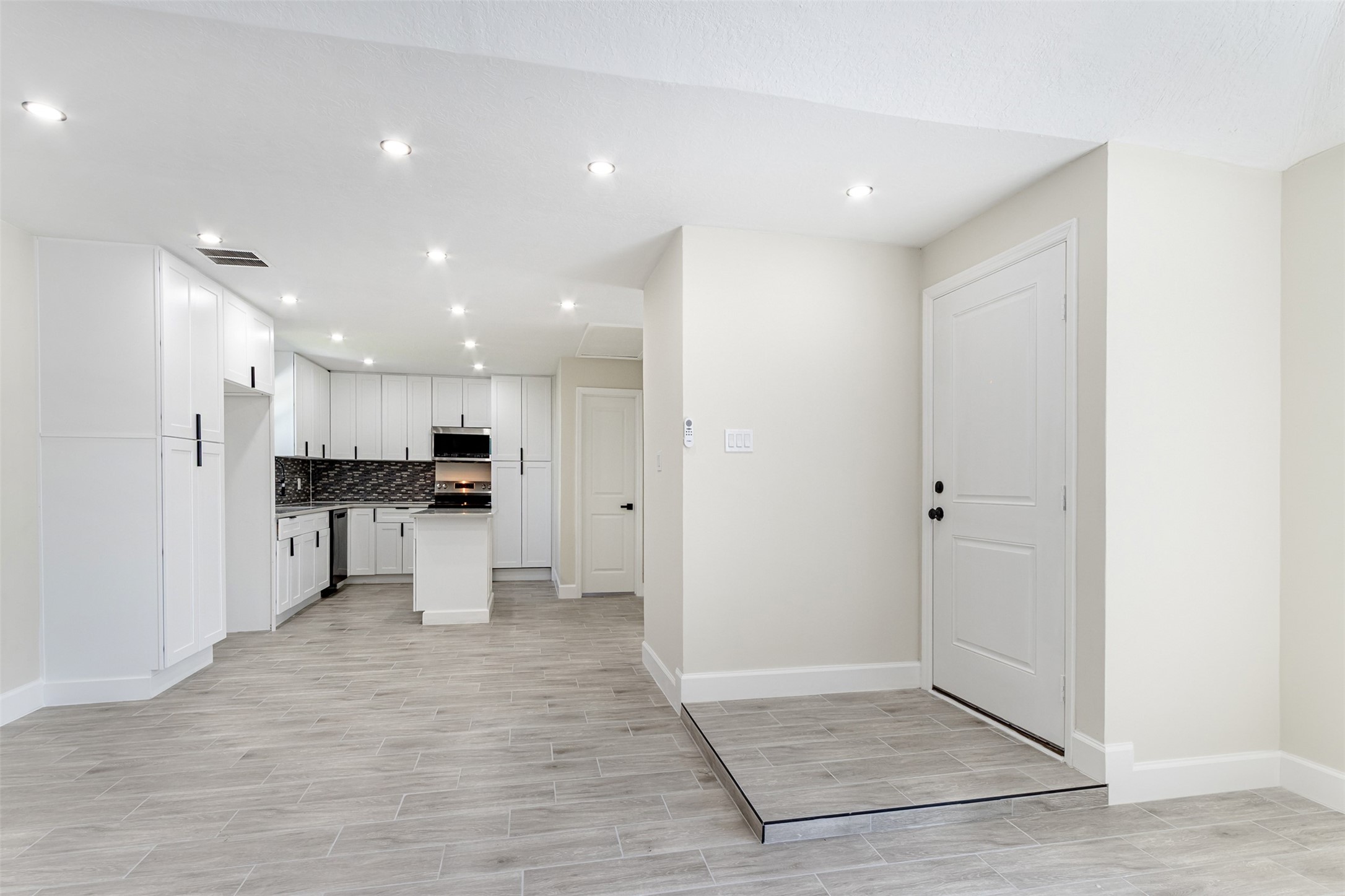 11203 Rousseau Drive Houston, TX 77065 - Photo 7 of 50 a view of kitchen with kitchen island white cabinets and refrigerator