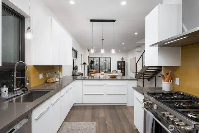a kitchen with stainless steel appliances a sink stove and cabinets