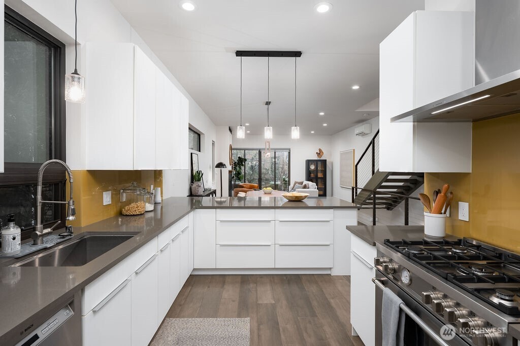 4815 Evanston Avenue North, Unit B Seattle, WA 98103 - Photo 12 of 37 a kitchen with stainless steel appliances a sink stove and cabinets
