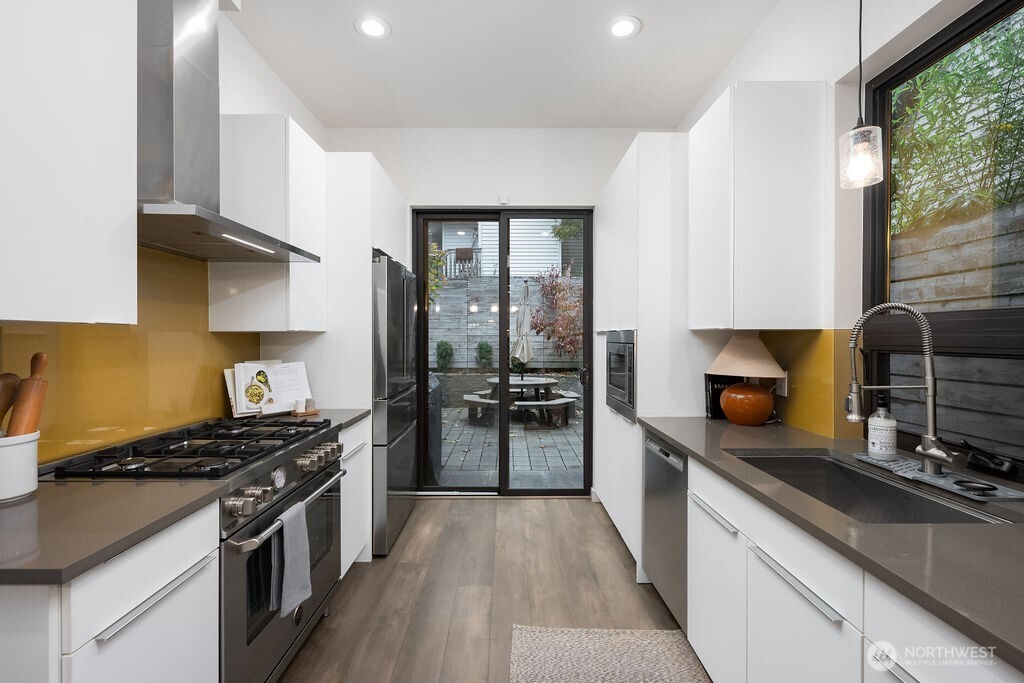 4815 Evanston Avenue North, Unit B Seattle, WA 98103 - Photo 14 of 37 a kitchen with stainless steel appliances granite countertop a stove and a sink