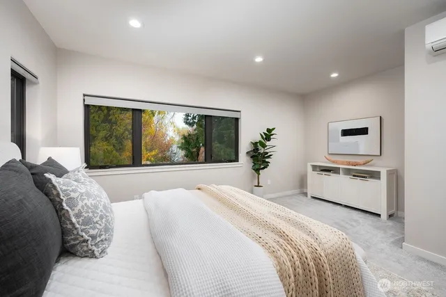 a spacious bedroom with a large bed and a large window