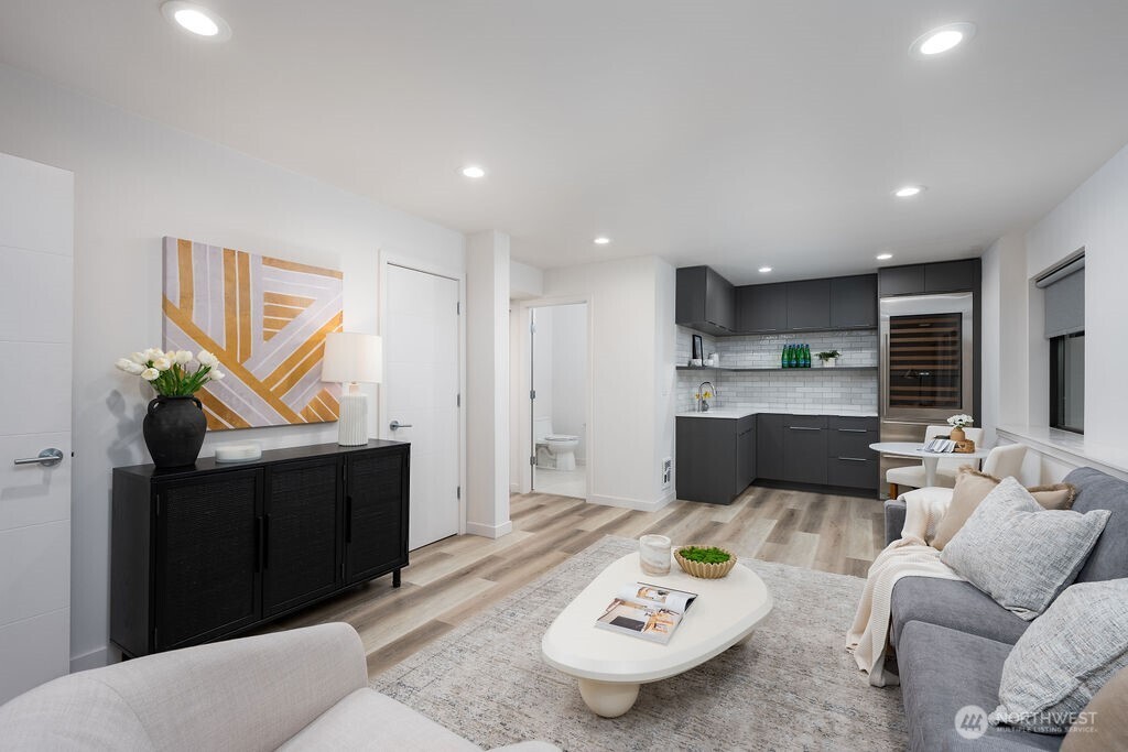 4815 Evanston Avenue North, Unit B Seattle, WA 98103 - Photo 27 of 37 a living room with furniture and a table