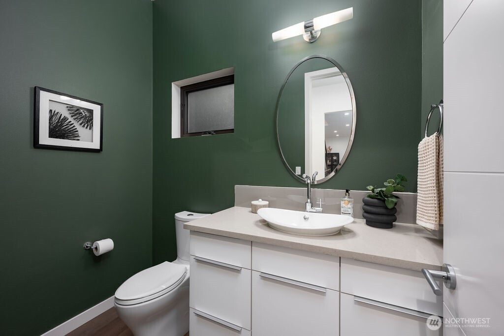 4815 Evanston Avenue North, Unit B Seattle, WA 98103 - Photo 29 of 37 a bathroom with a toilet sink and mirror
