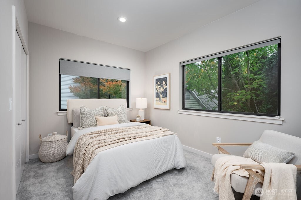 4815 Evanston Avenue North, Unit B Seattle, WA 98103 - Photo 30 of 37 a bedroom with a bed and a large window