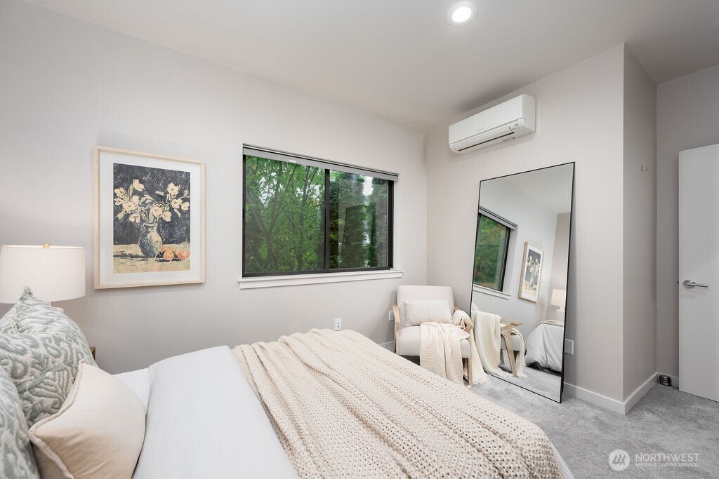 4815 Evanston Avenue North, Unit B Seattle, WA 98103 - Photo 31 of 37 a bedroom with a large bed and a window