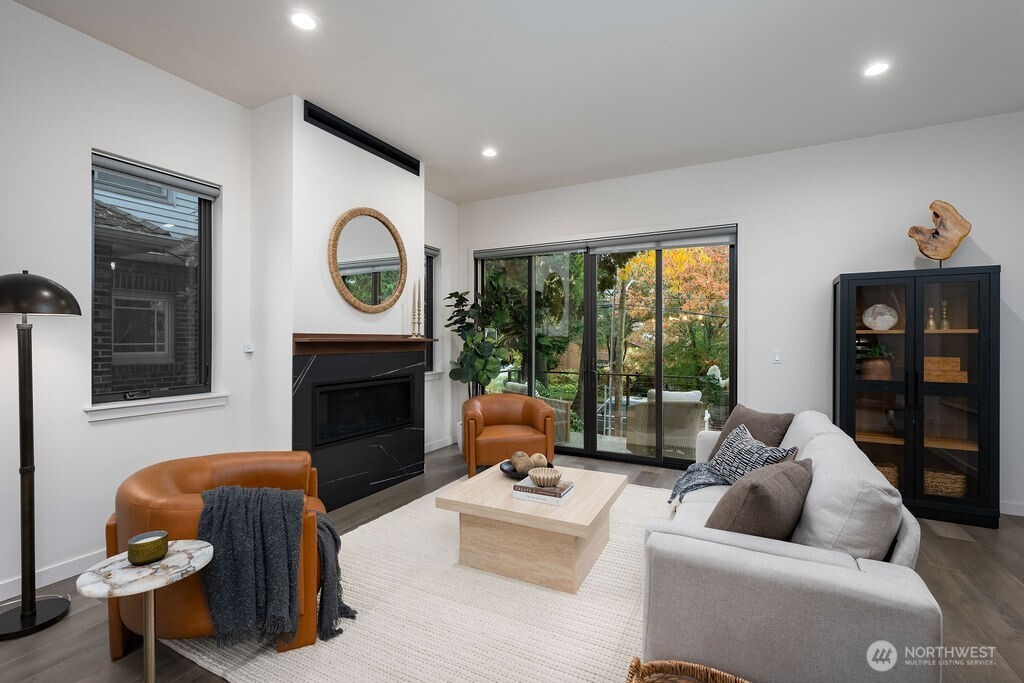 4815 Evanston Avenue North, Unit B Seattle, WA 98103 - Photo 7 of 37 a living room with furniture and a fireplace
