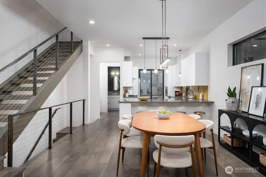 4815 Evanston Avenue North, Unit B Seattle, WA 98103 - Photo 8 of 37 a dining room with furniture a window and kitchen view