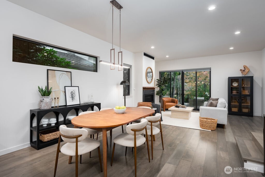 4815 Evanston Avenue North, Unit B Seattle, WA 98103 - Photo 10 of 37 a view of a dining room with furniture window and wooden floor