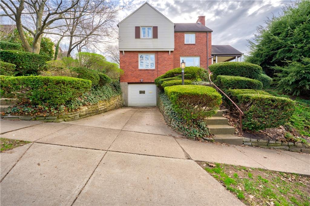 a front view of a house with garden