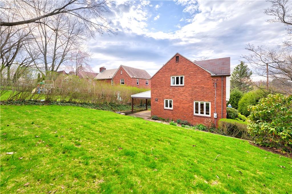 271 Newburn Drive Mt. Lebanon, PA 15216 - Photo 23 of 24 a brick house with a big yard and large trees