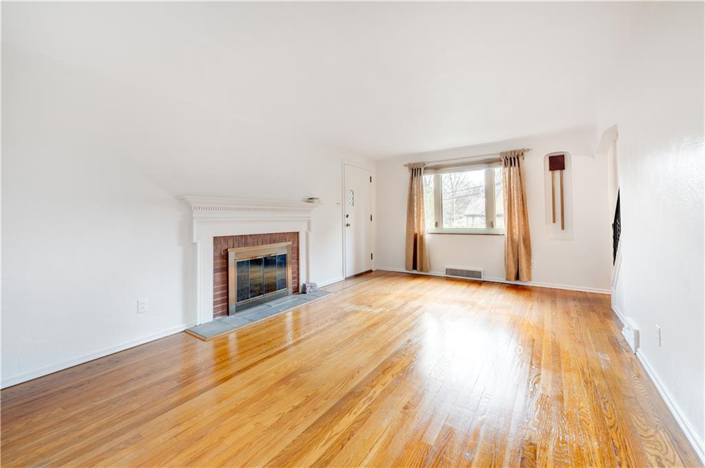 271 Newburn Drive Mt. Lebanon, PA 15216 - Photo 3 of 24 a view of empty room with wooden floor and fireplace