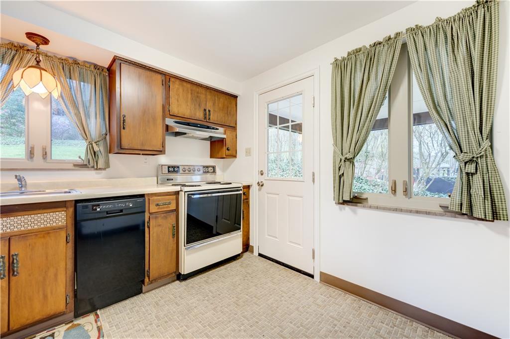 271 Newburn Drive Mt. Lebanon, PA 15216 - Photo 7 of 24 a kitchen with stainless steel appliances granite countertop a stove a sink and a microwave