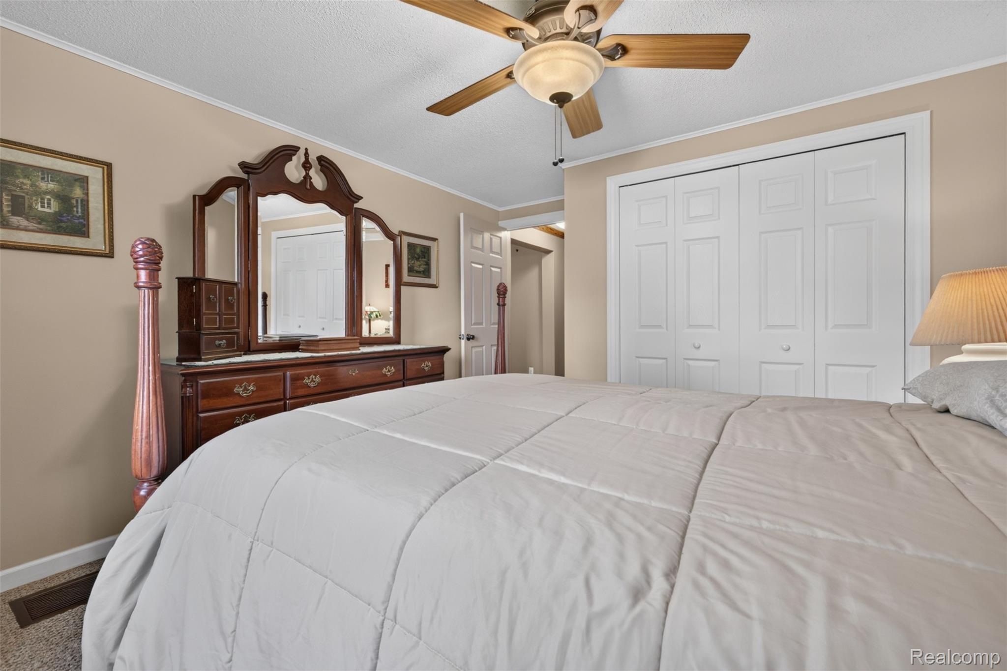 5977 Anglers Road Ortonville, MI 48462 - Photo 20 of 63 Neutral wall paint complements white trim and a ceiling fan with integrated lighting