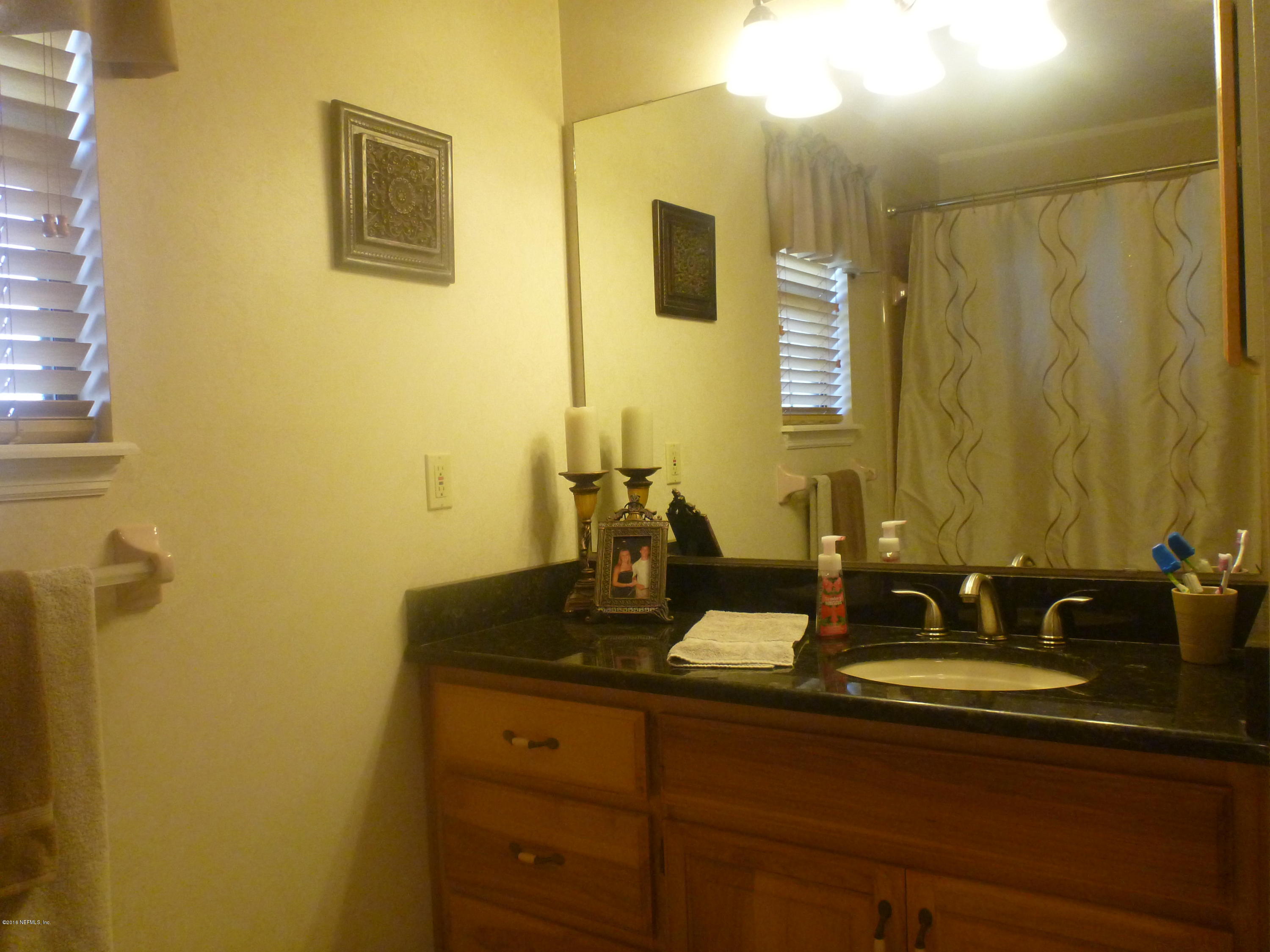 6285 Payne Road Keystone Heights, FL 32656 - Photo 12 of 31 a bathroom with a sink and a mirror