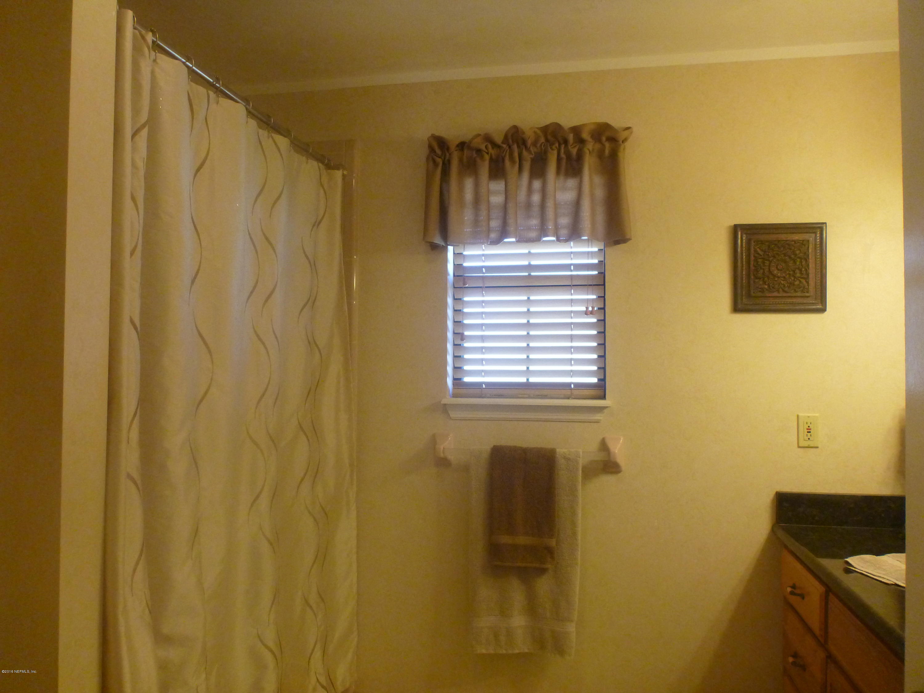 6285 Payne Road Keystone Heights, FL 32656 - Photo 13 of 31 a view of a bathroom with a window and a shower