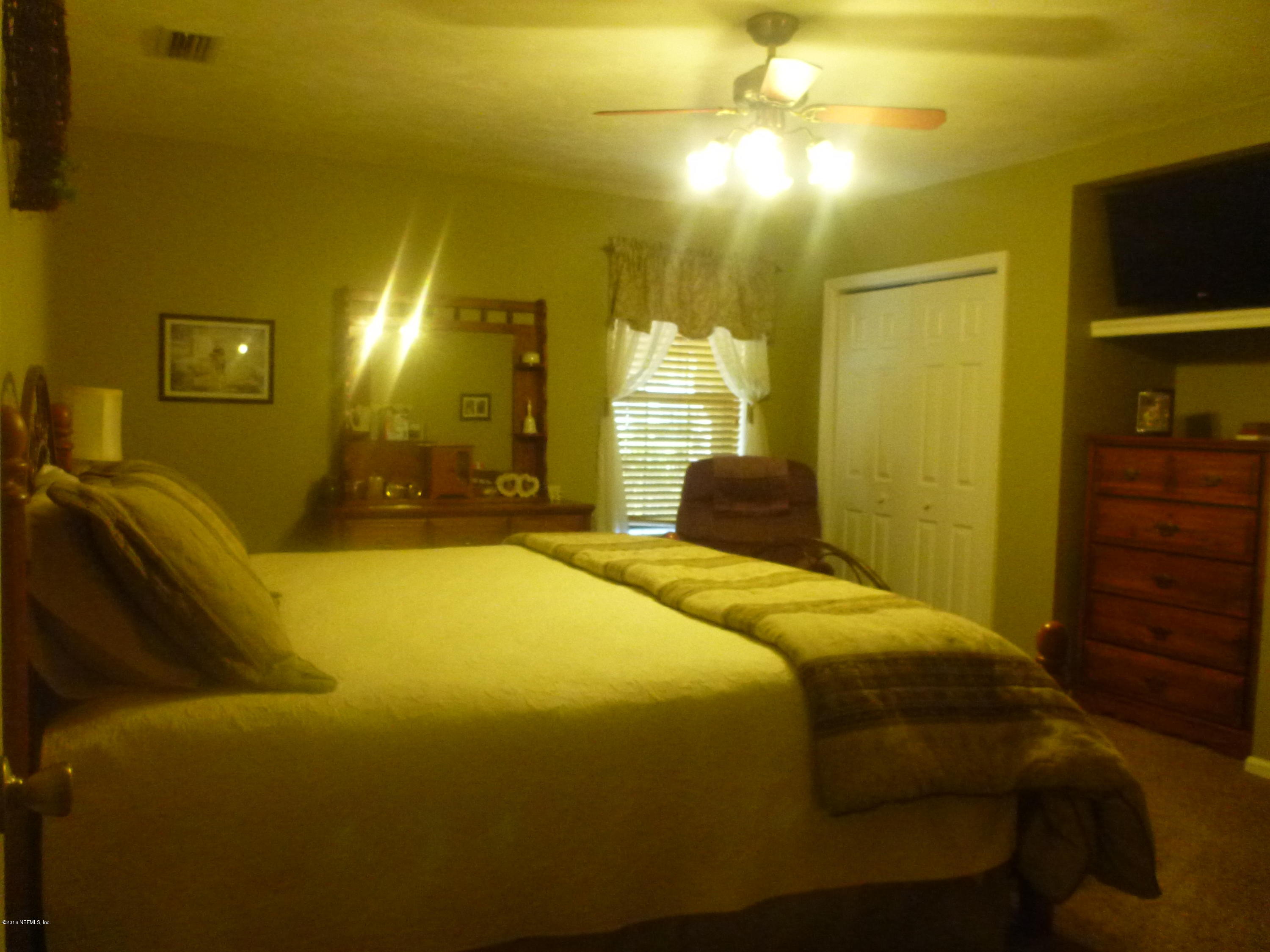 6285 Payne Road Keystone Heights, FL 32656 - Photo 14 of 31 a bedroom with a bed and dresser