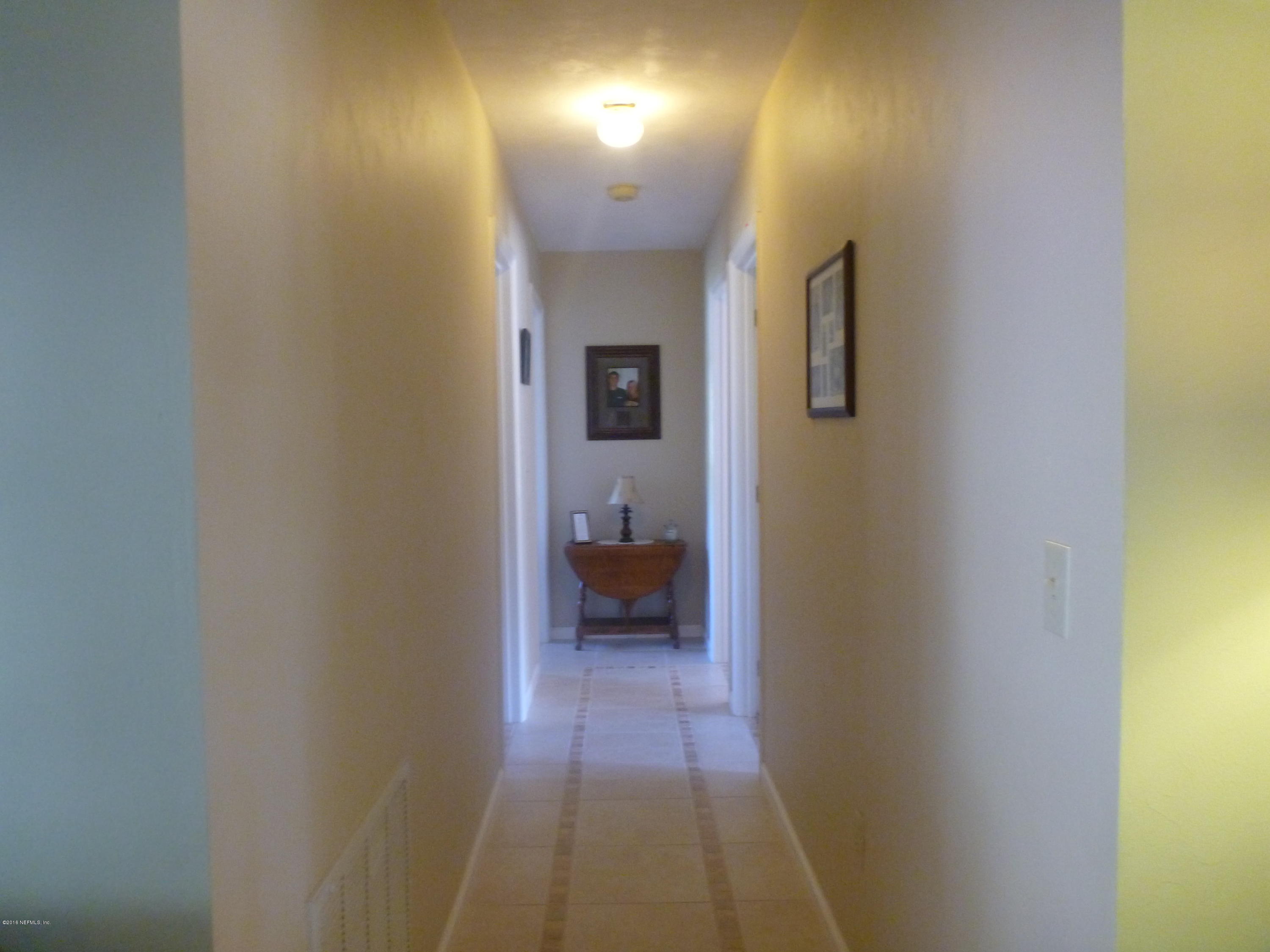 6285 Payne Road Keystone Heights, FL 32656 - Photo 8 of 31 a view of a hallway with wooden floor and a bathroom