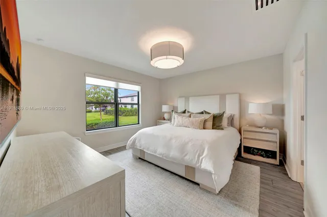 a spacious bedroom with a bed and a large window