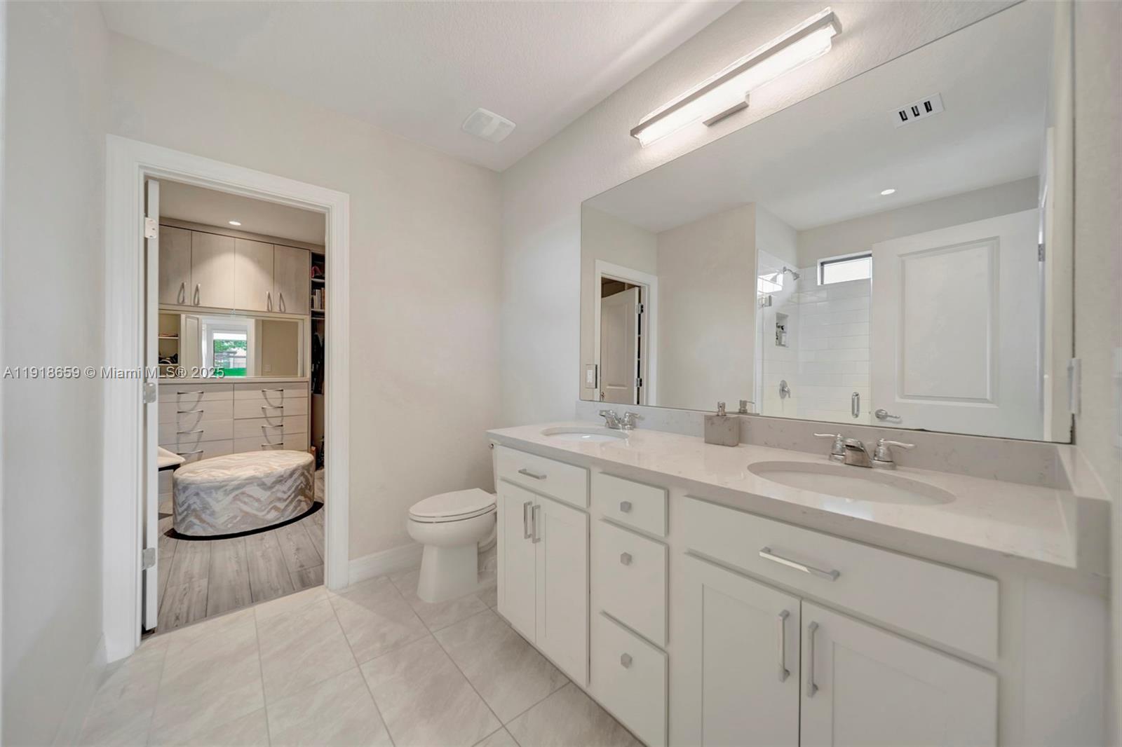 2941 Shortleaf Avenue Lauderdale Lakes, FL 33311 - Photo 12 of 47 a spacious bathroom with a double vanity sink a toilet and a mirror