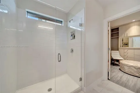 a bathroom with a glass shower door