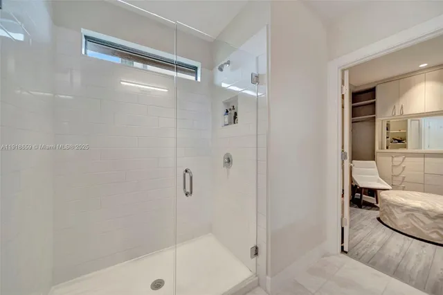 a bathroom with a glass shower door