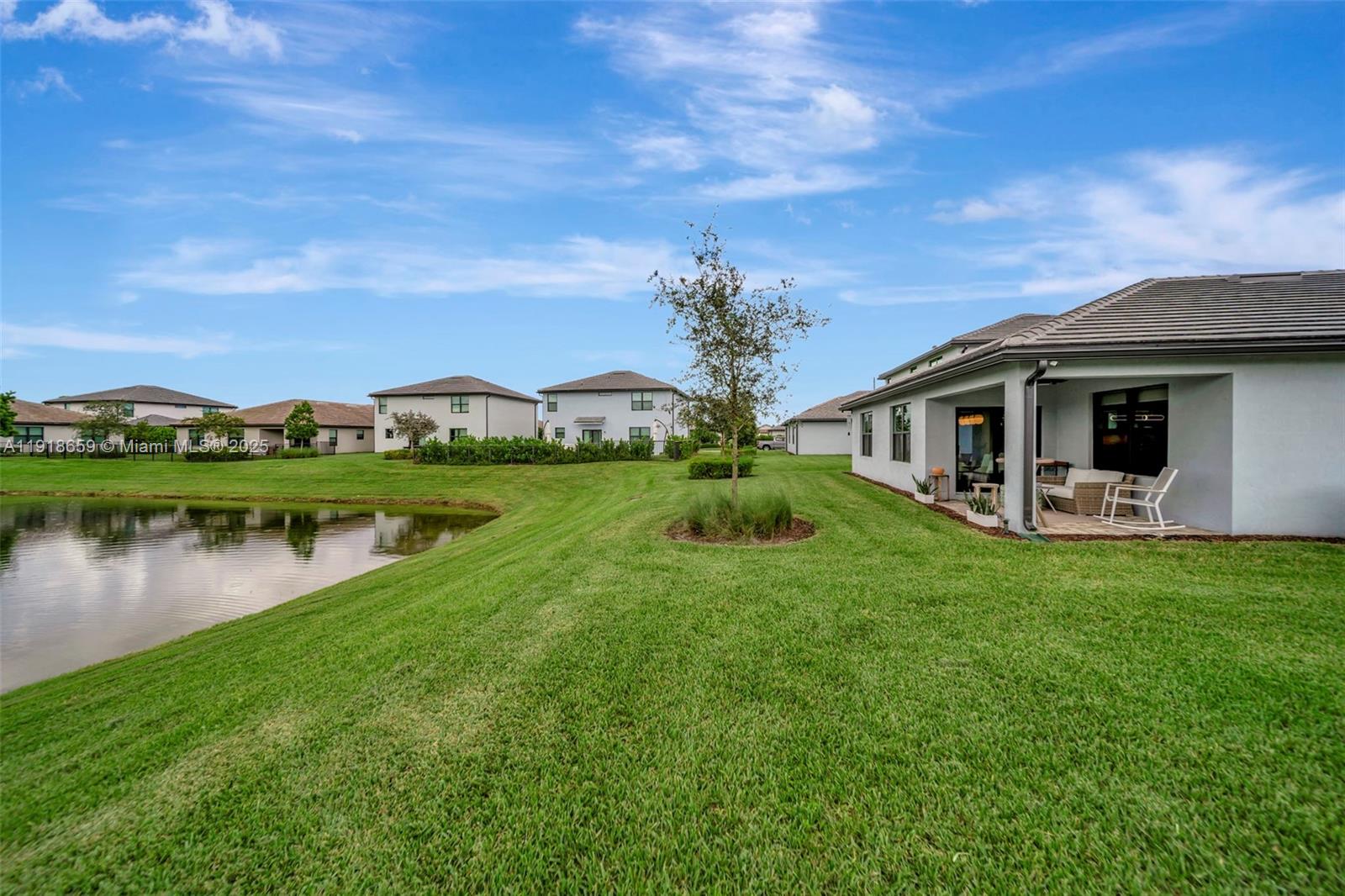 2941 Shortleaf Avenue Lauderdale Lakes, FL 33311 - Photo 2 of 47 a white house with a big yard and potted plants in front of it
