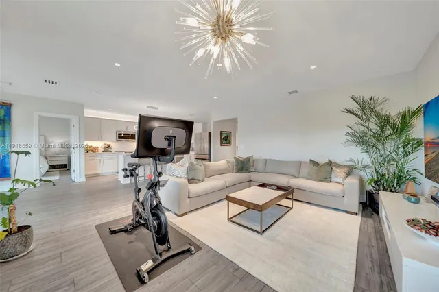 a living room with furniture or couch and a dining table with wooden floor