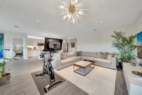 a living room with furniture or couch and a dining table with wooden floor