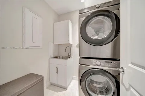 a utility room with sink dryer and washer