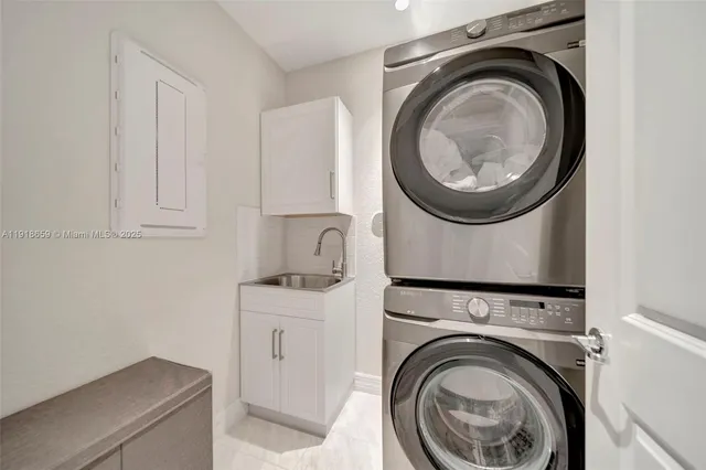 a utility room with sink dryer and washer