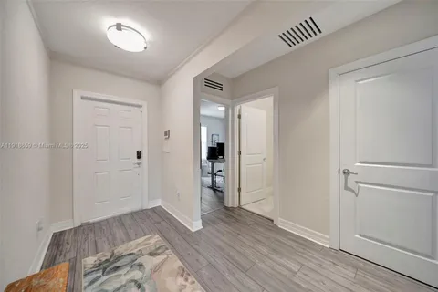 a view of empty room with wooden floor