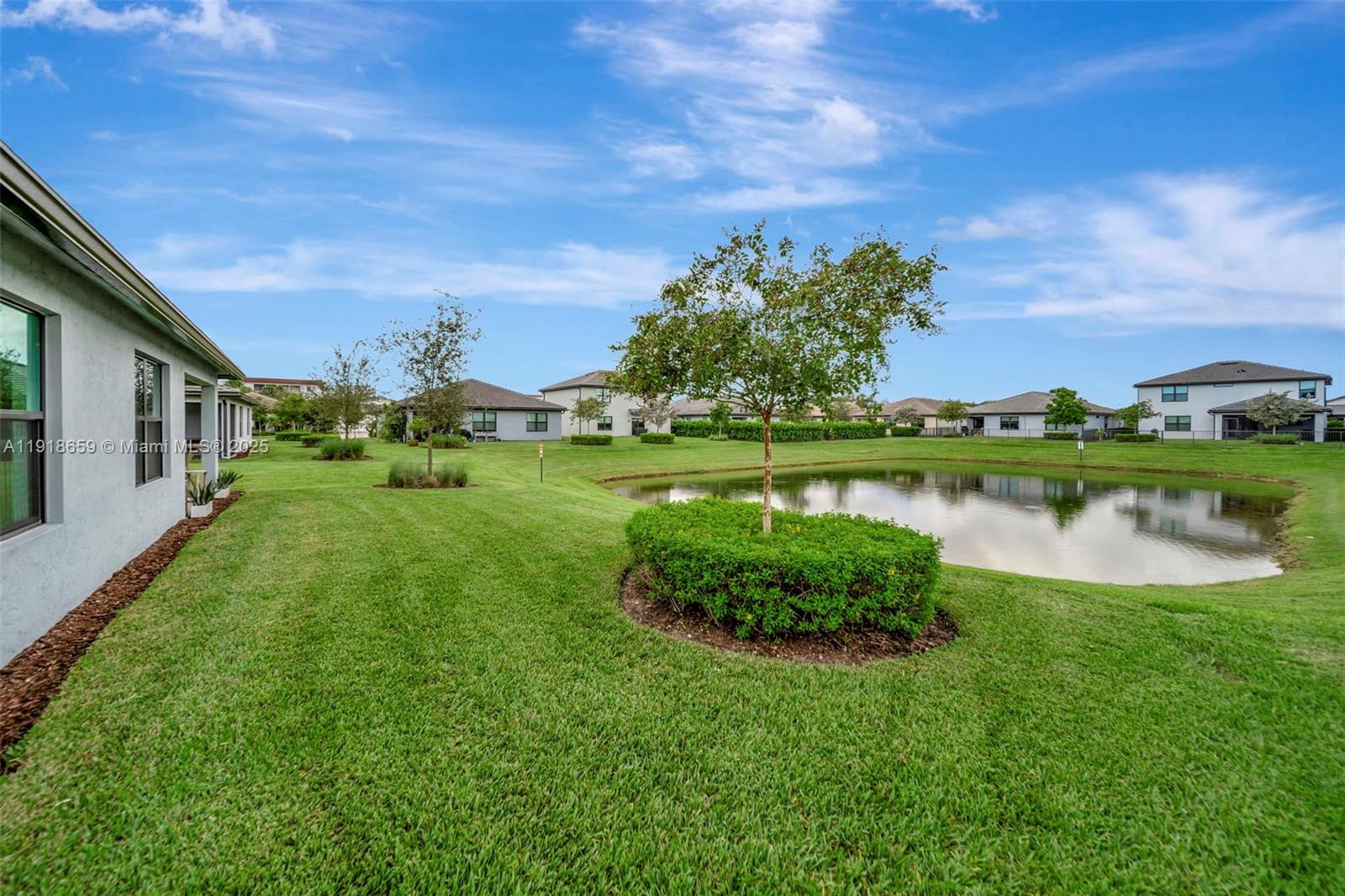 2941 Shortleaf Avenue Lauderdale Lakes, FL 33311 - Photo 40 of 47 a view of a lake with a house in the background