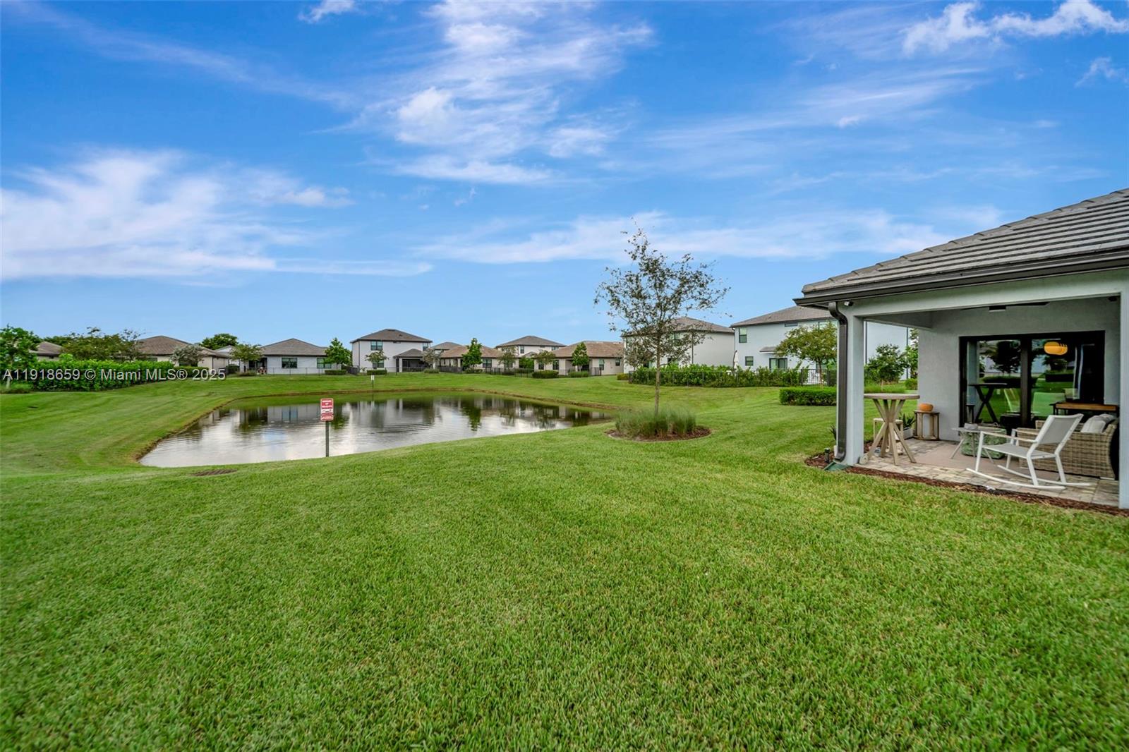 2941 Shortleaf Avenue Lauderdale Lakes, FL 33311 - Photo 42 of 47 a view of a house with a yard table and chairs