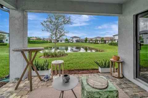 a view of a chairs and table in patio with a lake view