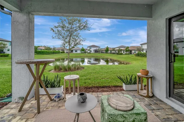 a view of a chairs and table in patio with a lake view