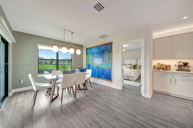 a dining room with furniture a rug and wooden floor