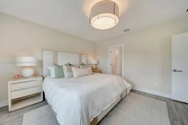 a bedroom with a bed and a chandelier