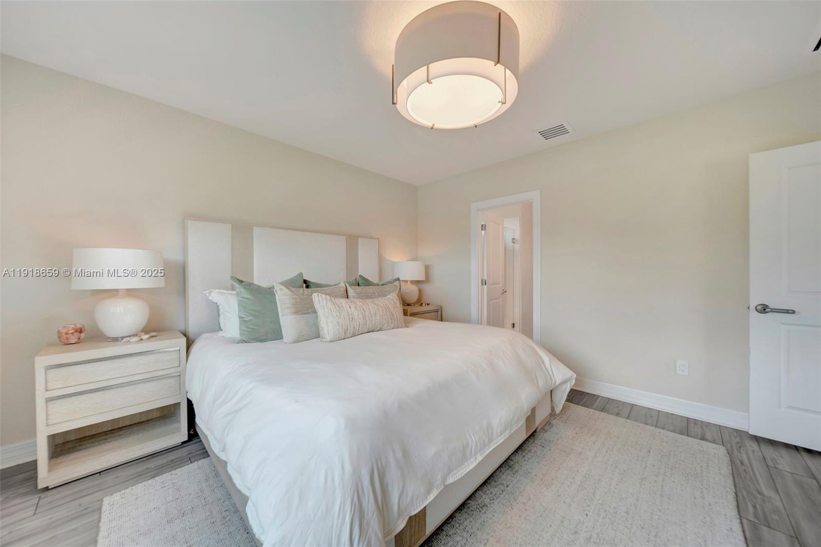 2941 Shortleaf Avenue Lauderdale Lakes, FL 33311 - Photo 10 of 47 a bedroom with a bed and a chandelier