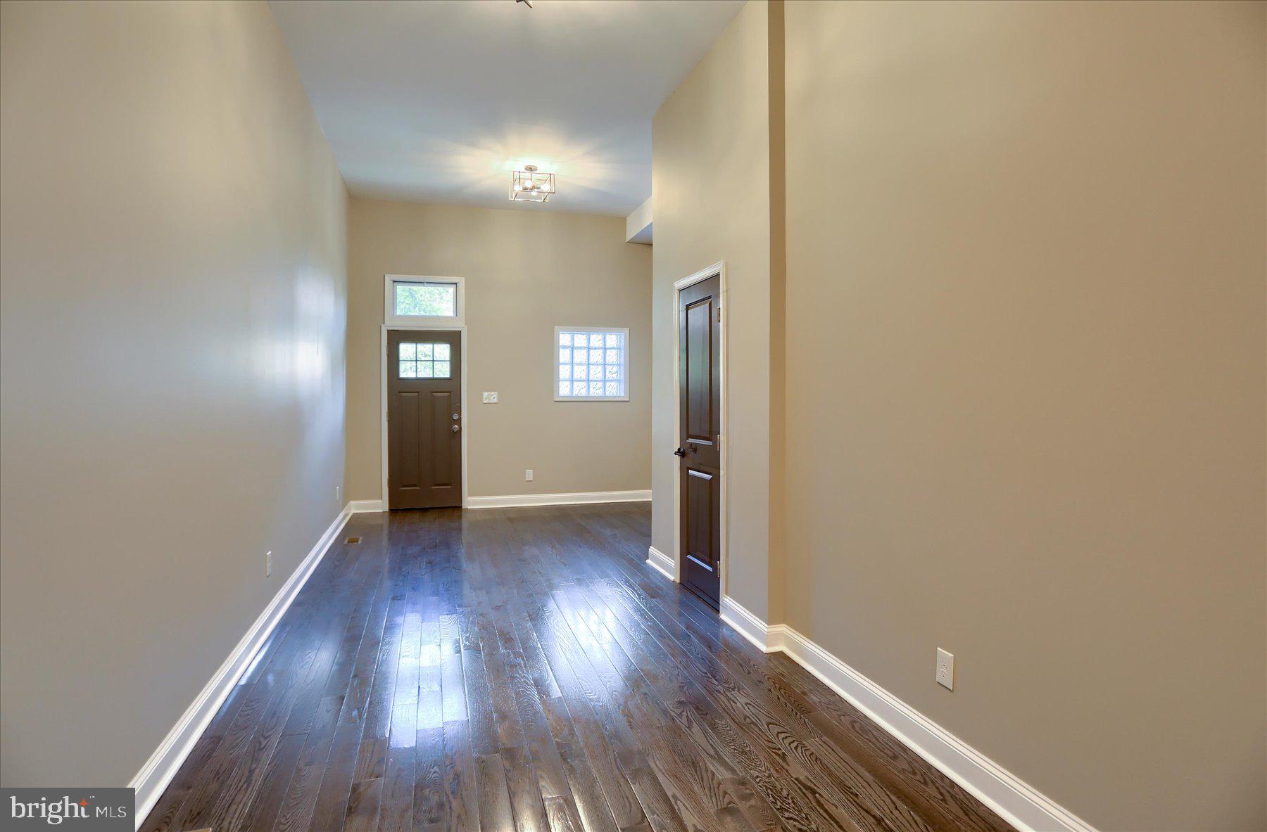 1811 Madison Avenue Baltimore, MD 21217 - Photo 11 of 37 a view of a room with wooden floor and window