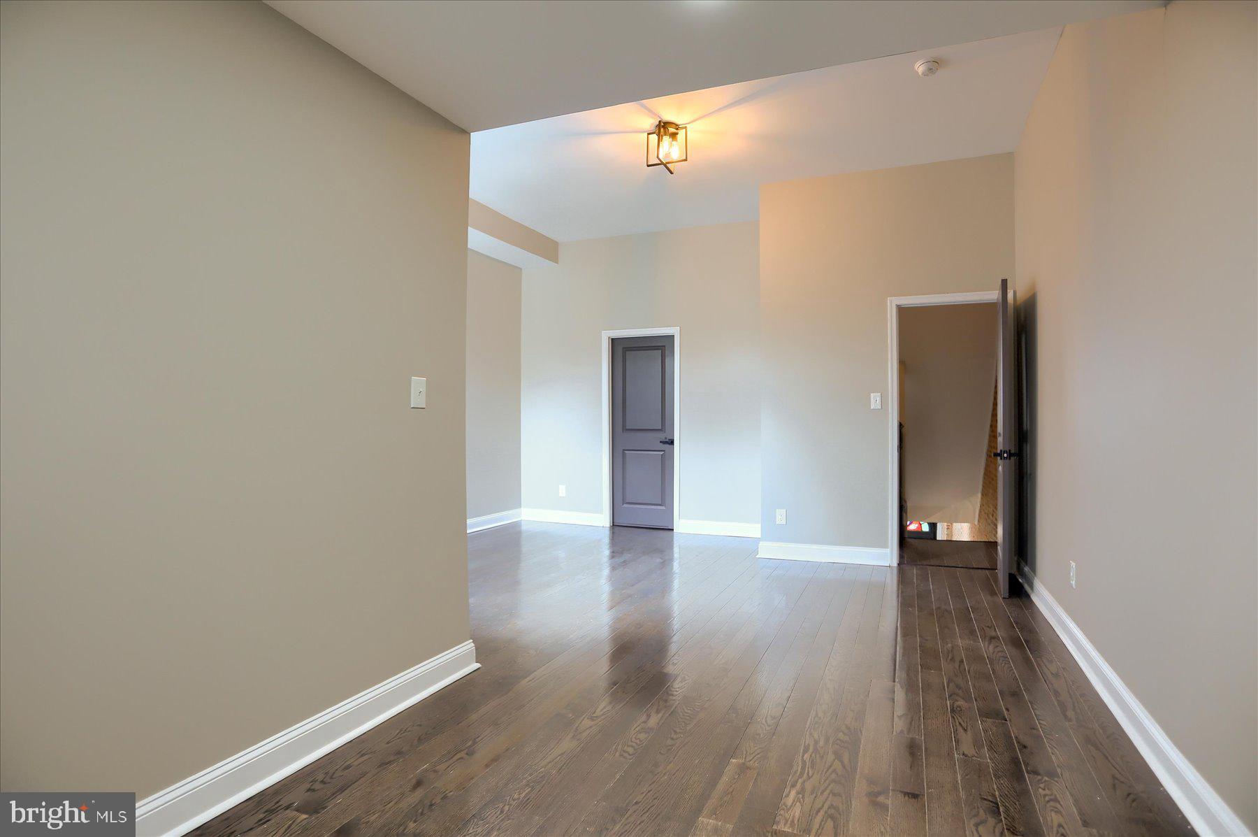 1811 Madison Avenue Baltimore, MD 21217 - Photo 17 of 37 a view of an empty room with wooden floor
