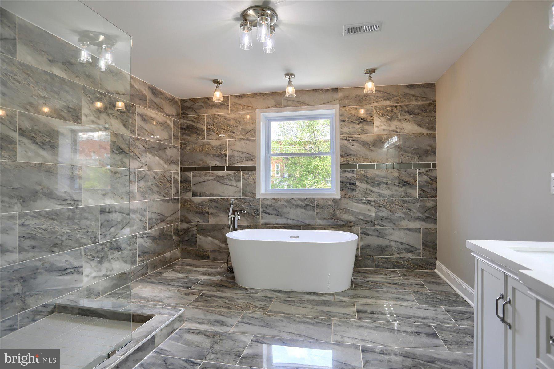 1811 Madison Avenue Baltimore, MD 21217 - Photo 20 of 37 a bathroom with a sink a toilet a mirror and shower