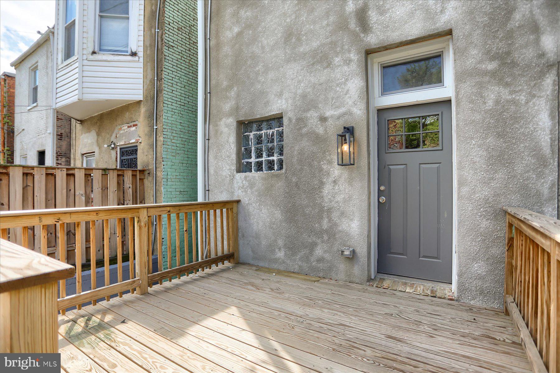 1811 Madison Avenue Baltimore, MD 21217 - Photo 34 of 37 a view of a balcony with wooden floor